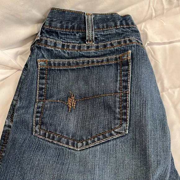 2 pairs of Arita low rise M4 boot jeans that are not hemmed